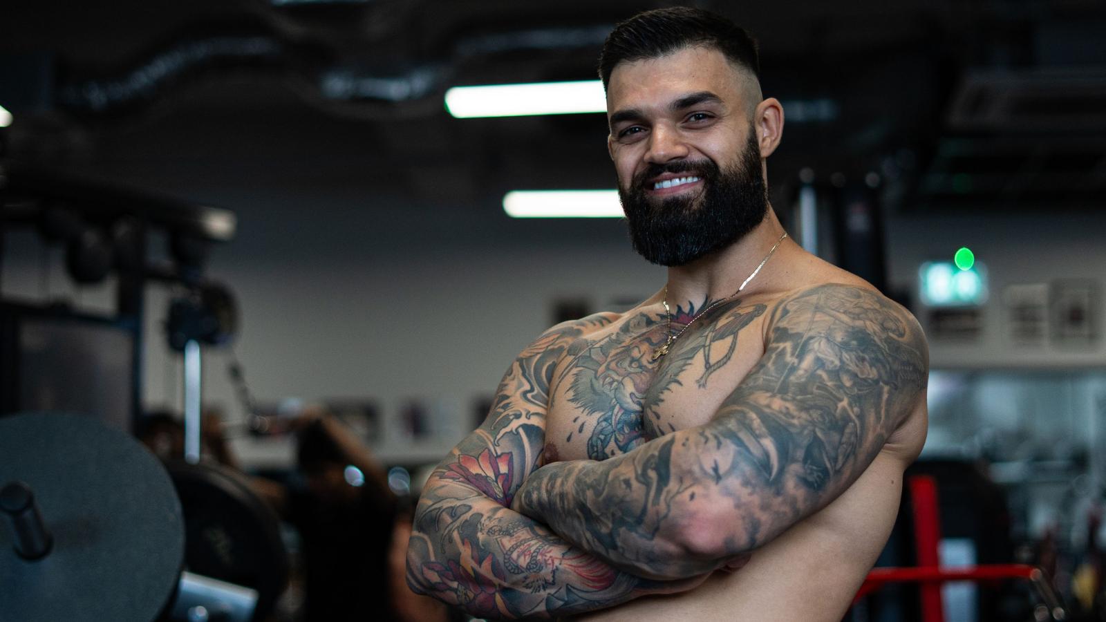 Personal trainer with a dumbbell, smiling